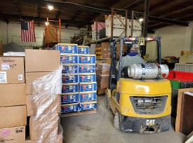 Charlie using Habitat for Humanity's forklift